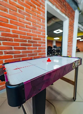 Air hockey table setup at Riveria by V Stays for indoor gaming fun