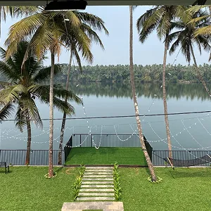 View of Chaliyar River beside Riveria by V Stays with calm water and greenery