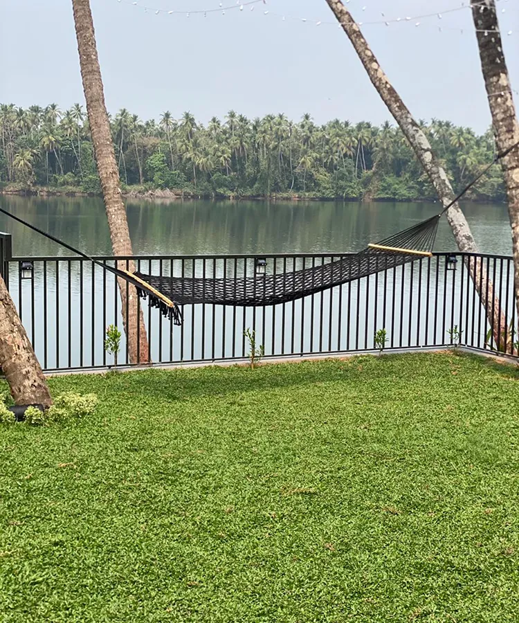 View of Chaliyar River beside Riveria by V Stays with calm water and greenery